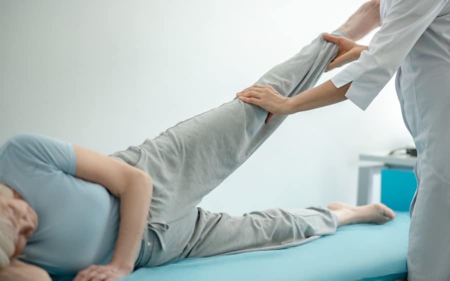 stock-photo-orthopedist-doctor-examining-the-legs-joints-of-an-elderly-woman-1841698144