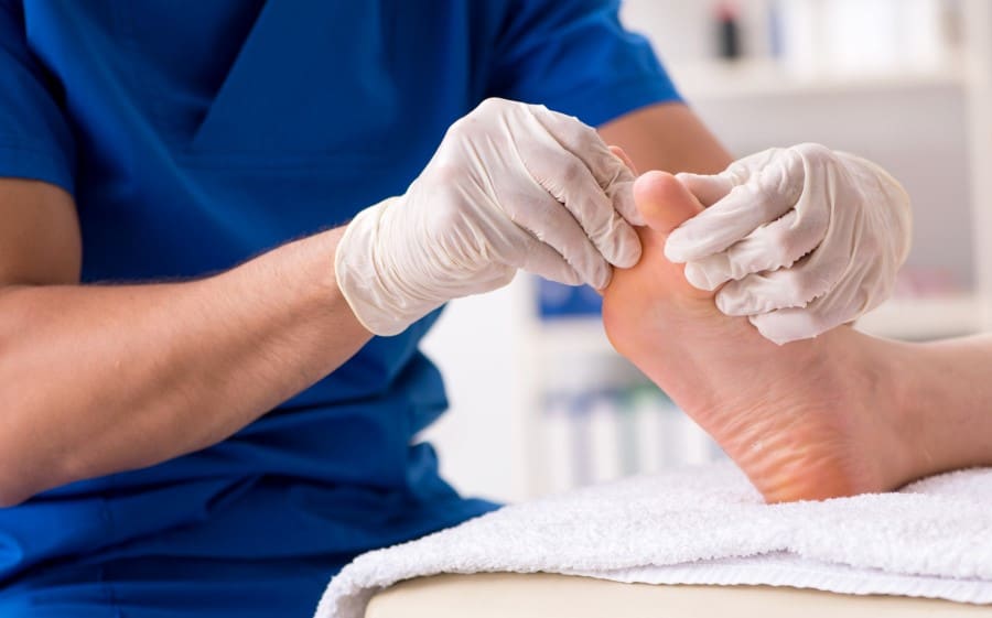 stock-photo-podiatrist-treating-feet-during-procedure-1408206383